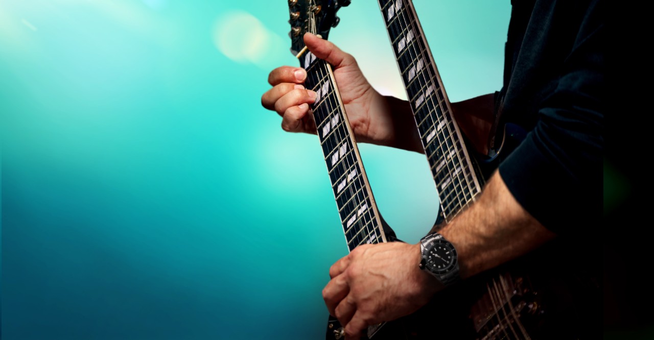 A Street Musician Performs a Solo on an Electric Double-Necked Guitar; Shutterstock ID 1408920644; Purchase Order: -