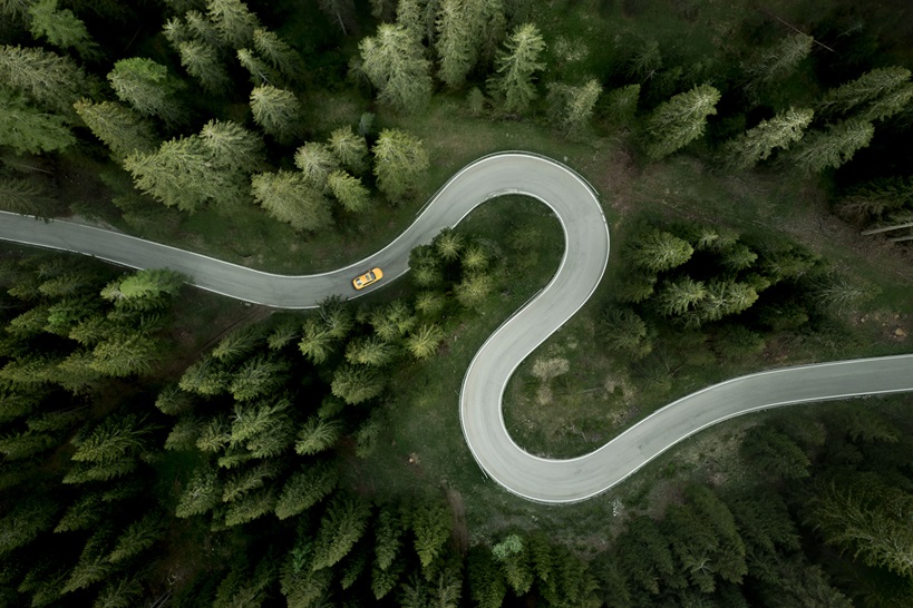 Overhead view of car driving on s-shape mountain road, Giau Pass, Dolomites, Veneto, Italy