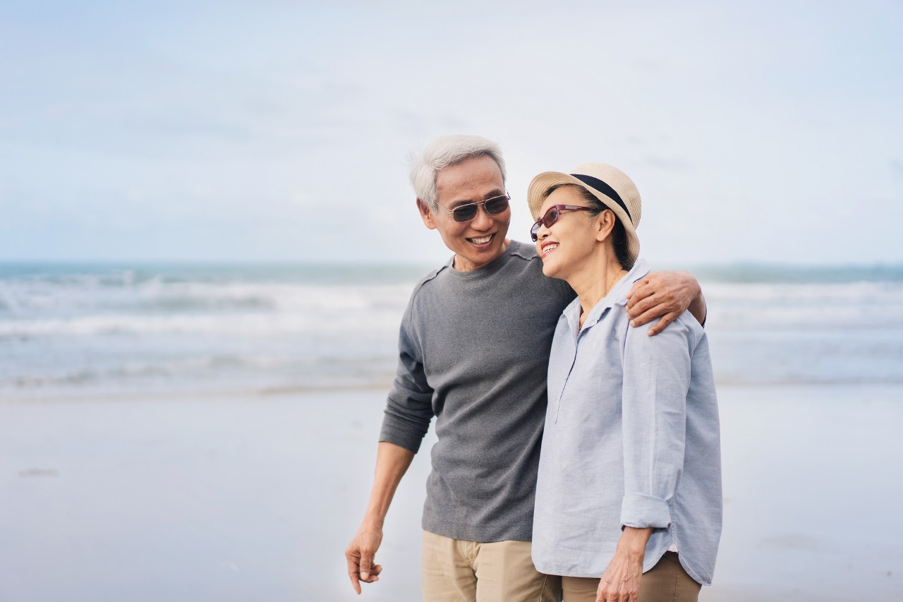 happy senior couple have fun and enjoy outdoor leisure activity at the beach.  enjoy together a retired lifestyle at the beach. smiling and laughing persons