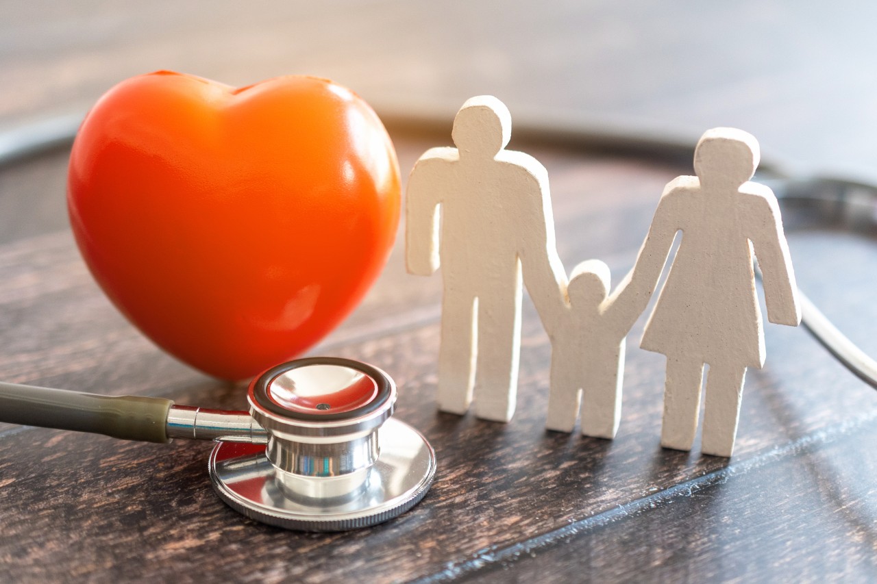 Red heart, stethoscope and icon family on wooden desk. Medical Insurance Concept 
