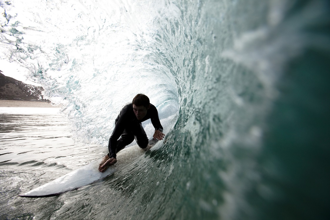A male surfer navigates the barrel while surfing at Westward in Malibu, California on July 23, 2009.  Westward is an extremely powerful wave that suits only the most skilled surfers.